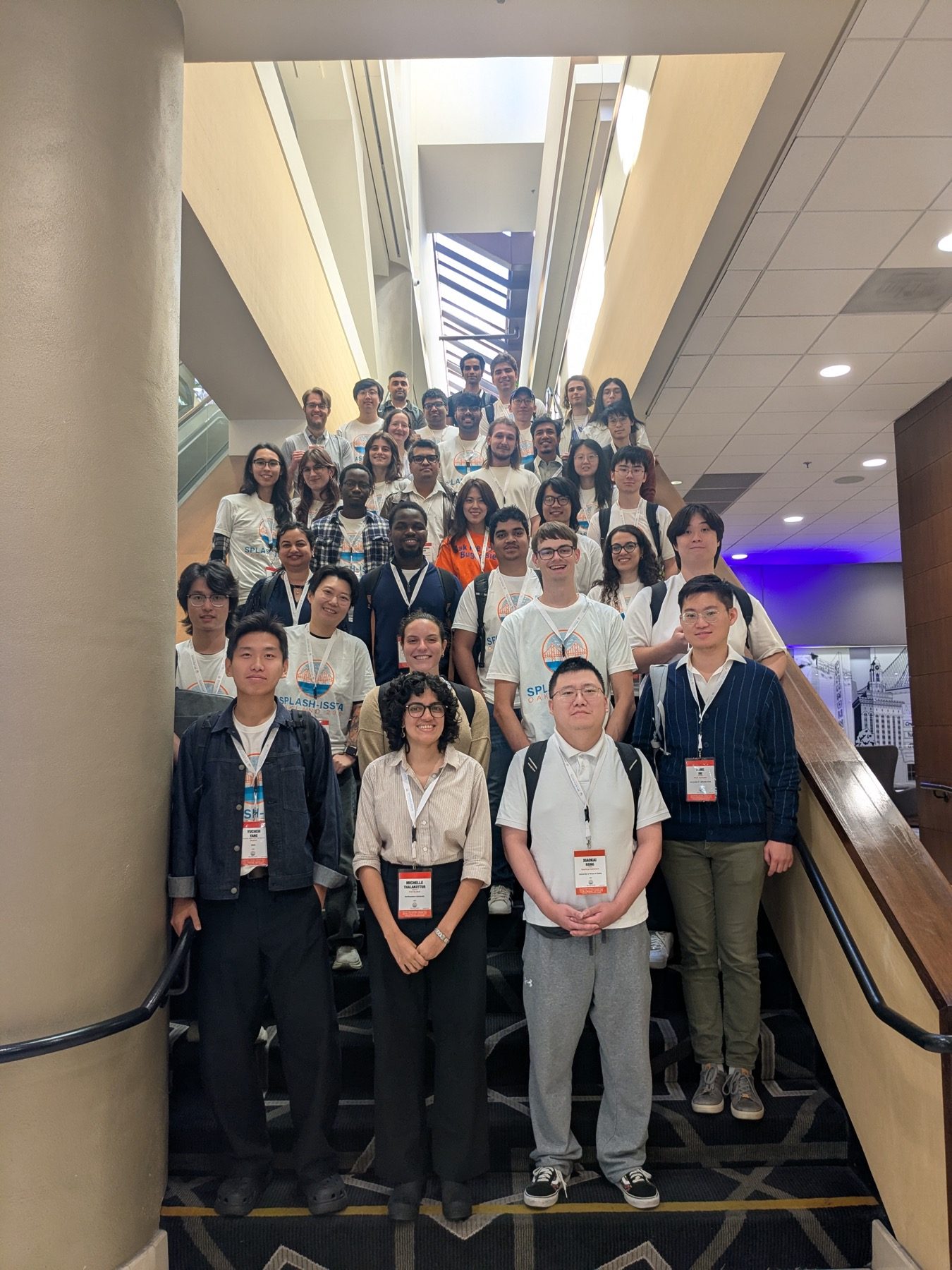 Group photo of the SPLASH/ISSTA 2026 student volunteers on a staircase at the conference hotel in Oakland.